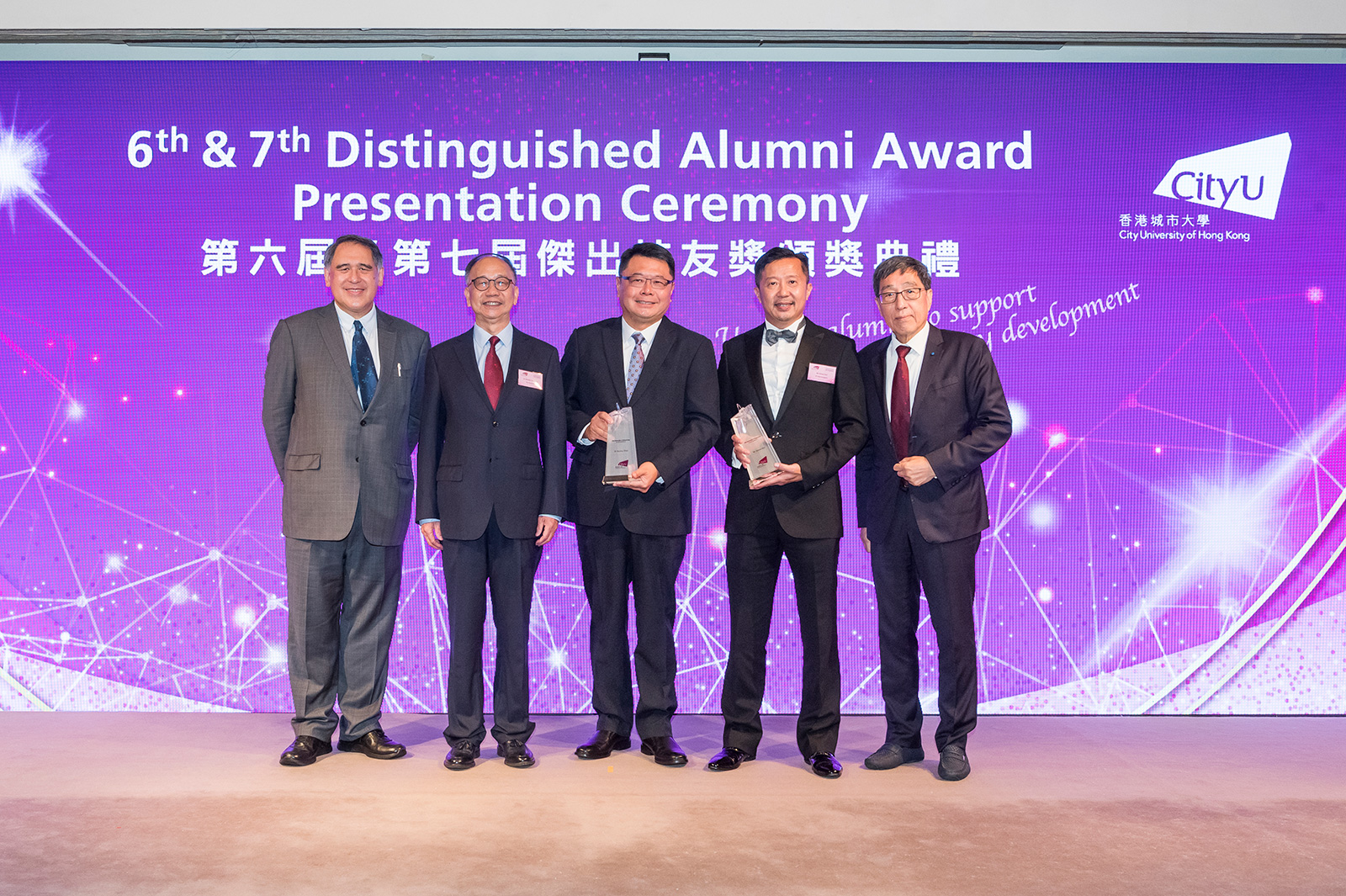 Mr Simon Hui (second from right) and Dr Sunny Chai (third from right) are conferred the 6th and 7th Distinguished Alumni Award of CityU, respectively. The ceremony was officiated by Dr Chung Shui-ming, CityU Pro-Chancellor (second from left), Mr Lester Garson Huang, CityU Council Chairman (first left), and Professor Way Kuo, CityU President (first right).